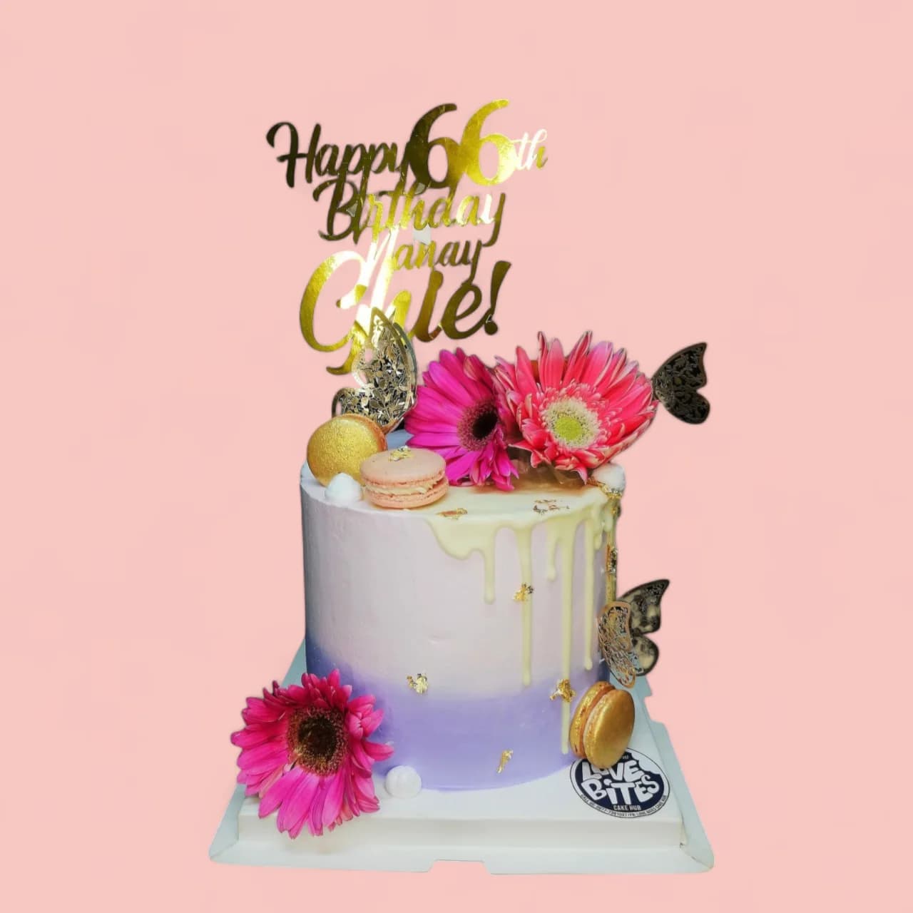 Custom Light Purple with Pink Flowers and Macaron-Themed Birthday Cake by Love Bites Cake Hub