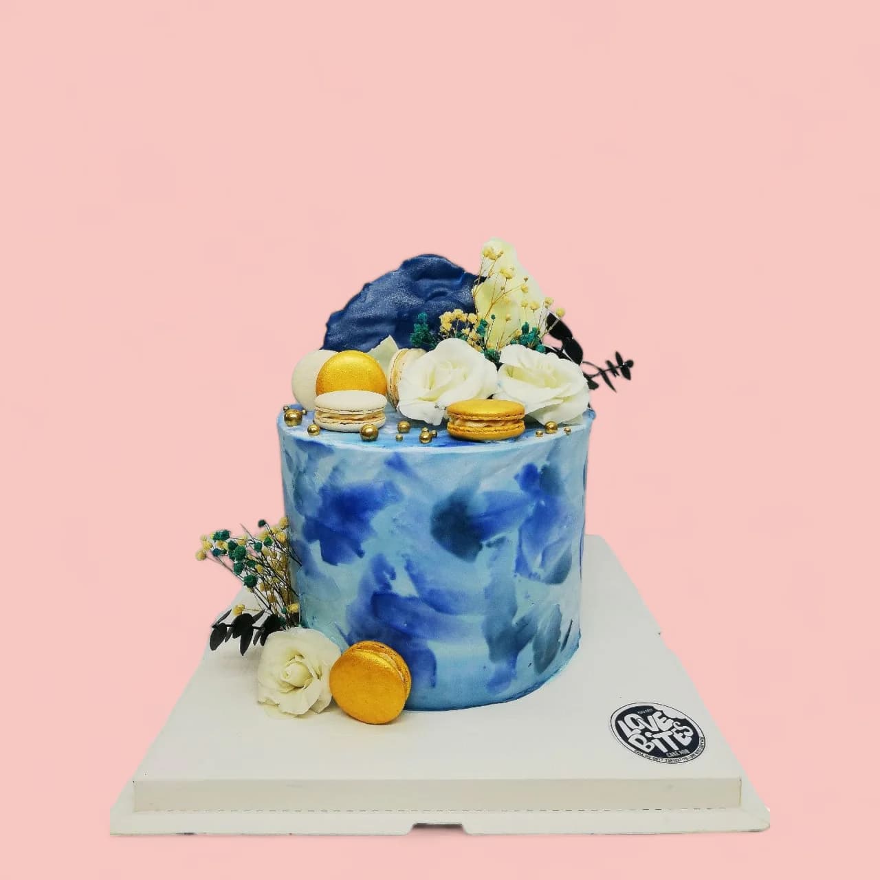 Custom Blue with White and Gold Flowers and Macaron-Themed Birthday Cake by Love Bites Cake Hub